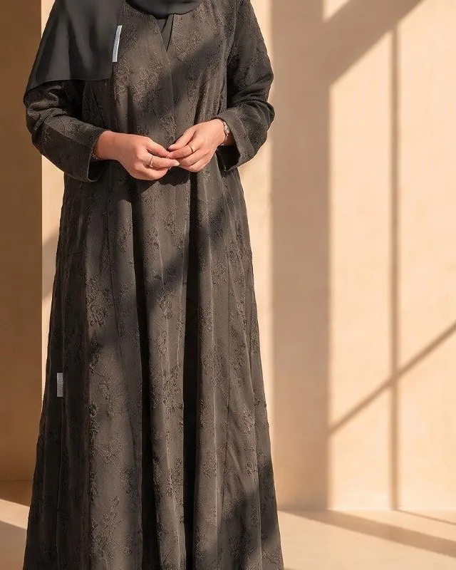 Close view of the tonal floral jacquard on the charcoal abaya