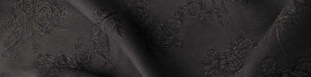 Close-up of a charcoal fabric with a tonal floral jacquard